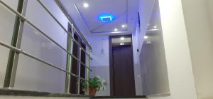 a hallway with a door with a sign on the ceiling at Benda Rejuvenate Hotel in Jodhpur