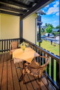 a table and chairs on a deck with a view of a park at Parkpension Spreewald in Burg