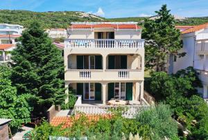 an aerial view of a white house with a balcony at Apartments Laci in Stara Novalja