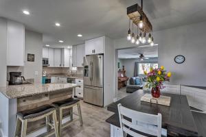 a kitchen with a dining table and a refrigerator at Montrose Adventure Base Near Skiing and San Juans! in Montrose