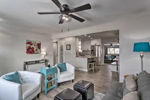 a living room with a couch and a ceiling fan at Montrose Adventure Base Near Skiing and San Juans! in Montrose