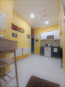 a kitchen with yellow walls and a table in a room at 'A Funtanella in Naples