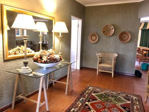 a room with a table with a bowl of fruit on it at Summerplace Holiday Home in Hazyview