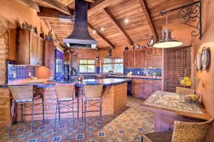 een keuken met houten kasten en barkrukken bij Equestrian Estate with Horse Stables and Pool! in Valley Center