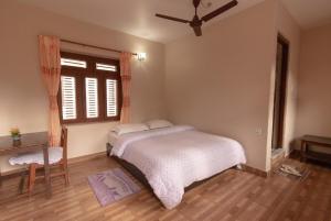 A bed or beds in a room at New Tourist Guest House
