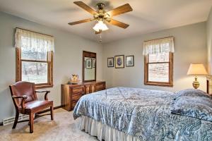 a bedroom with a bed and a ceiling fan at Wisconsin River Valley Farmhouse Fire Pit and View in Merrimac