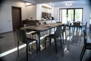 a dining room with a large wooden table and chairs at Pensiunea Negoiu in Porumbacu de Sus