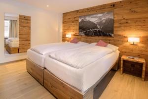 Ένα ή περισσότερα κρεβάτια σε δωμάτιο στο Hotel Bernerhof Grindelwald