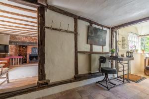 a living room with a table and a chair at The Old Post Office in Higham