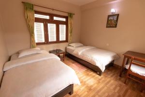 A bed or beds in a room at New Tourist Guest House