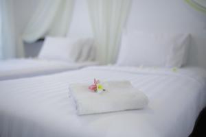 Ένα ή περισσότερα κρεβάτια σε δωμάτιο στο Aman Dan Laut