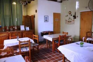 a restaurant with tables and chairs with white table cloth at La Casona de Susana in Colón