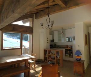a kitchen with a table and a dining room at Les 7 laux immobilier chalet F in Prapoutel