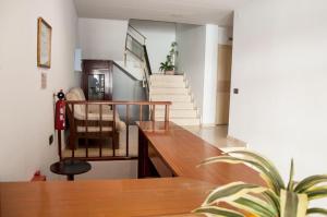 a living room with stairs and a table and a chair at Hostal Fontdemora in Mora la Nueva