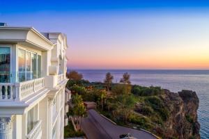 a building with a view of the ocean at sunset at La Boutique Hotel & Suites in Antalya