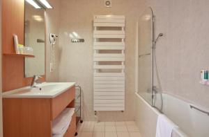 a bathroom with a sink and a shower at Logis Hotel des Lacs in Celles-sur-Plaine