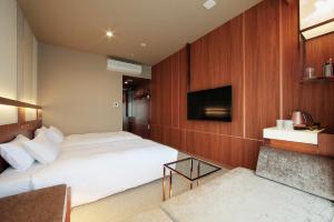 Postel nebo postele na pokoji v ubytování Candeo Hotels Omiya