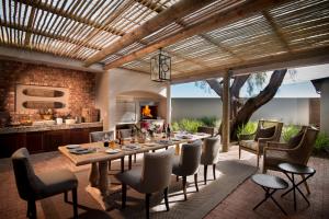 a dining room with a table and chairs at Kwandwe Fort House in Grahamstown