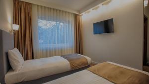 MER Guest House B&B客房内的一张或多张床位
