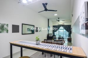 a dining table in a living room with a ceiling fan at Bandar Saujana Putra BSP 21 AZFA Suite [FREE WiFi] in Jenjarum +35 photos