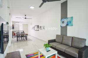 a living room with a couch and a table at Bandar Saujana Putra BSP 21 AZFA Suite [FREE WiFi] in Jenjarum