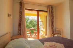 a bedroom with a bed and a door to a patio at Villa Agata in Dajla +32 photos