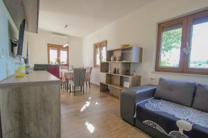 a living room with a couch and a kitchen and a table at Villa Agata in Dajla