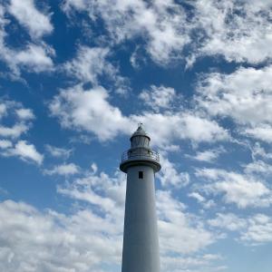 a white and blue lighthouse on a cloudy day at Ogawa Ryokan in Shimoda