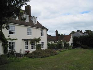 a white house with a yard in front of it at Beaver Cottage in Aldeburgh
