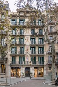 
a large building with a clock on the front of it at Be Mate Paseo de Gracia in Barcelona

