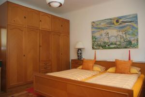 a bedroom with a bed and a painting on the wall at Guesthouse 7even in Mostar