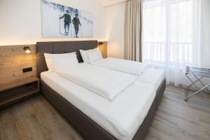 Posteľ alebo postele v izbe v ubytovaní ALPRIMA Aparthotel Hinterstoder