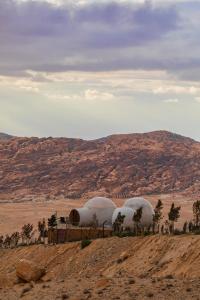 three domes sitting on top of a hill in the desert at Petra Bubble Luxotel in Wadi Musa