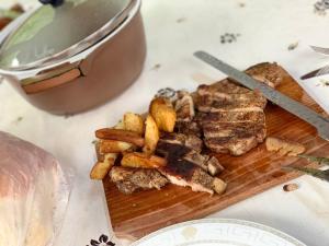 a steak and french fries on a cutting board at Casa Perla Nordului in Moisei