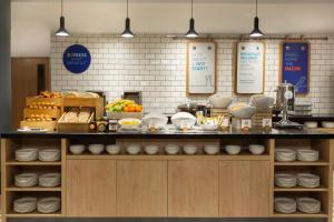 a kitchen counter filled with lots of different types of food at Holiday Inn Express Cheltenham Town Centre, an IHG Hotel in Cheltenham
