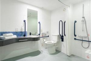 
a bathroom with a toilet a sink and a shower at Holiday Inn Express Cheltenham Town Centre, an IHG Hotel in Cheltenham

