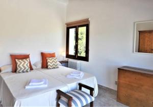 a white room with a bed and a window at Villa LAS ENCINAS-en el pueblo de Esporles- Mallorca in Esporles