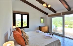 a bedroom with a bed and a large window at Villa LAS ENCINAS-en el pueblo de Esporles- Mallorca in Esporles +54 photos