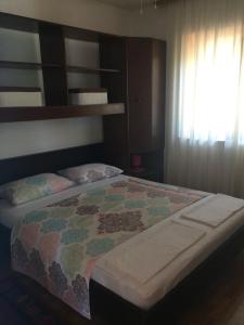 a bedroom with a bed with a quilt on it at Apartments Tomović in Korčula