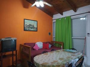 a living room with a couch and a television at Casa Reinamora in Villa Parque Siquiman