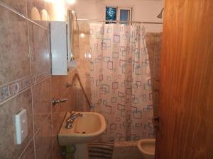 a bathroom with a sink and a shower curtain at Casa Reinamora in Villa Parque Siquiman