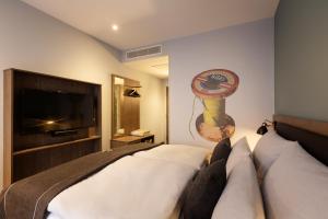 Ένα ή περισσότερα κρεβάτια σε δωμάτιο στο Holiday Inn - the niu, Loom Manchester North by IHG