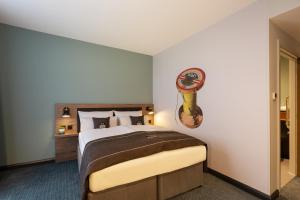 Ένα ή περισσότερα κρεβάτια σε δωμάτιο στο Holiday Inn - the niu, Loom Manchester North by IHG