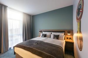 Ένα ή περισσότερα κρεβάτια σε δωμάτιο στο Holiday Inn - the niu, Loom Manchester North by IHG