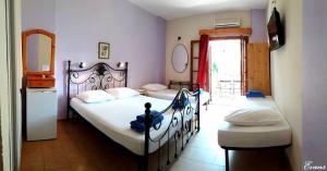 A bed or beds in a room at EVANS Skiathos