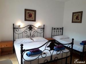 A bed or beds in a room at EVANS Skiathos