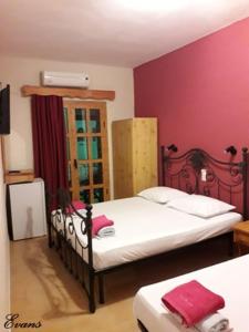 A bed or beds in a room at EVANS Skiathos