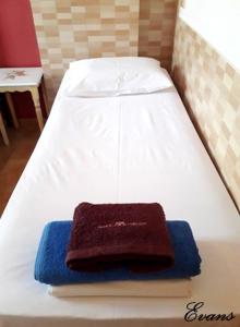 A bed or beds in a room at EVANS Skiathos