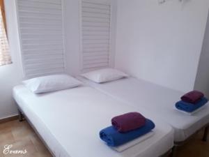 A bed or beds in a room at EVANS Skiathos