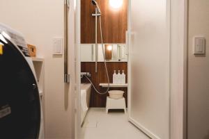 a small bathroom with a toilet and a sink at SO Kyoto Fushimi Inari in Kyoto +48 photos